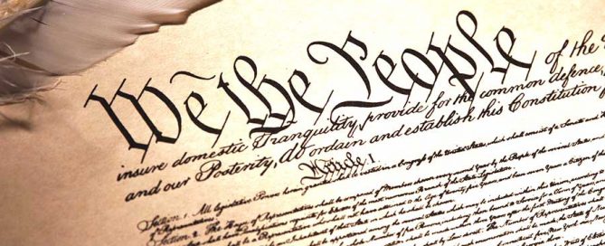 Image of the first page of the US constitution with a feature writing quill.